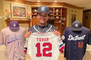 P.J. Jones Jr. with a No. 12 jersey from his grandfather, Cesar Tovar. He wears No. 12 for Cretin-Derham Hall and the Little Caesar’s national 16-an