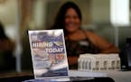 FILE - A hiring sign is placed at a booth for prospective employers during a job fair Wednesday, Sept. 22, 2021, in the West Hollywood section of Los 
