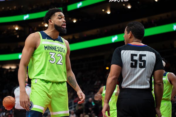 Minnesota Timberwolves center Karl-Anthony Towns (32) talks to referee Bill Kennedy during the first half of the team's NBA basketball game against th