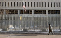 A pedestrian made his way in front of a gated Warren E. Burger Federal Building as jury selection begins in the trial of ex-Minneapolis officers charg