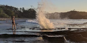 Pacific waves burst though a tidal blowhole at Playa Pelada in Nosara, Costa Rica.