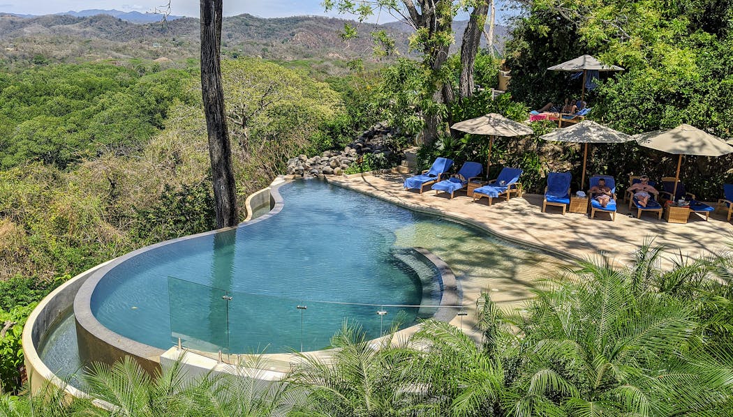 Hotel Boutique Lagarta Lodge's infinity pool overlooks the lodge's own private wildlife refuge in Nosara, Costa Rica.