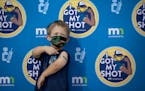 Zach Bakke, 8, of Minnetonka posed for a photo on a selfie wall after getting a COVID-19 vaccine on Dec. 2 at Mall of America in Bloomington.