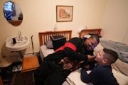 Shuntay Thomas listened to music with his son Brandon, 10, in their room in the Project Home at the Provincial House in the Highland Park neighborhood