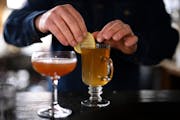 Bartender Dan Odell garnishes the “Not Hot Toddy” with a lemon at WA Frost and Company in St. Paul, Minn. The drink substitutes whiskey with the G