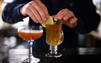 Bartender Dan O’Dell garnishes the Not Hot Toddy with a lemon at WA Frost and Co. in St. Paul. The drink uses a Gnista Barreled Oak spirit instead o