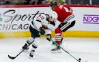 Wild left wing Kevin Fiala controls the puck against Blackhawks defenseman Seth Jones during the first period Friday night.