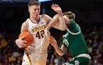 Treyton Thompson battles for a rebound for the Gophers.