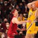 Minnesota guard Luke Loewe (12) looks to pass off the ball under pressure from Rutgers guard Paul Mulcahy (4) in the second half.