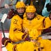 Gophers forward Emily Oden and wing Peyton Hemp celebrate with forward Addie Burton after she scored in the first period Saturday.