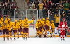 The University of Minnesota women’s hockey team celebrates after defeating Wisconsin 4-3 and claiming the series sweep Saturday, Jan. 22, 2022 in Ri