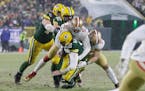 San Francisco’s Arik Armstead sacks Green Bay’s Aaron Rodgers during the second half of Saturday’s NFC divisional playoff in Green Bay