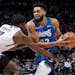 Center Karl-Anthony Towns drove on the Nets’ Day’Ron Sharpe in the first quarter of the Wolves’ 136-125 victory at Target Center on Sunday.