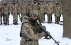 An instructor trains members of Ukraine’s Territorial Defense Forces, volunteer military units of the Armed Forces, in a city park in Kyiv, Ukraine,