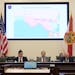 Florida Sen. Ray Rodrigues, center, views redistricting maps on a video monitor as an identical one is displayed behind him during a Senate Committee 