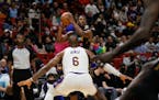 Los Angeles Lakers forward LeBron James (6) defends Miami Heat forward Jimmy Butler (22) during the second quarter.