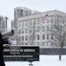 A woman walks past the U.S. Embassy in Kyiv, Ukraine, Monday, Jan. 24, 2022. The State Department is ordering the families of all American personnel a