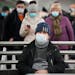 A man wearing a face mask to help protect against the spread of the coronavirus, sits in an underground in St. Petersburg, Russia, Monday, Jan. 24, 20