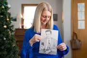 Barbara Teed holds a photo of her father, Arnold Weigel, in her home in Bloomington. Weigel was a Realtor who was forced out of the business in the 19