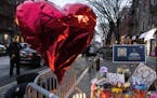 A makeshift memorial is seen outside the New York City Police Department’s 32nd Precinct, near the scene of a shooting days earlier in the Harlem ne