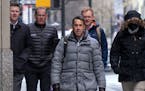 Major League Baseball deputy commissioner Dan Halem, center, arrives for a meeting in New York, Monday, Jan. 24, 2022, for the first in-person basebal