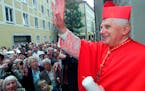 FILE - The Vatican’s Prefect for the Doctrine of the Faith, Cardinal Joseph Ratzinger, later to become Pope Benedict XVI, waves to faithful followin
