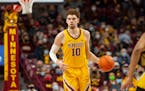 Minnesota forward Jamison Battle (10) brings the ball up court against Iowa in the first half of an NCAA college basketball game Sunday, Jan. 16.