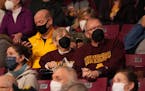 Betty and Don Cooke of Minnetonka wear masks as they watch from the stands in the first half of an NCAA men’s basketball game between the Minnesota 