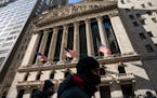 A pedestrian passes the New York Stock Exchange, Jan. 24, 2022, in New York. 