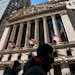 A pedestrian passes the New York Stock Exchange, Jan. 24, 2022, in New York. 