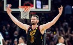 Kevin Love (0) reacts after hitting a 3-point shot in the first half.