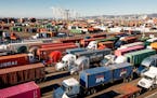 FILE - Trucks line up to enter a Port of Oakland shipping terminal on Wednesday, Nov. 10, 2021, in Oakland, Calif. The U.S. economy grew at a 2.3% rat