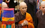 Vietnamese Zen master Thich Nhat Hanh, center, arrives for a great chanting ceremony at Vinh Nghiem Pagoda in Ho Chi Minh City, Vietnam on March 16, 2