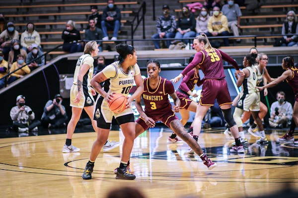 The Gophers’ Deja Winters defends Purdue’s Jeanae Terry on Thursday night in West Lafayette, Ind.