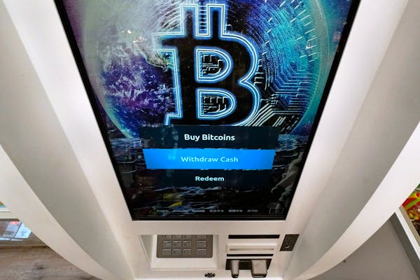 The Bitcoin logo appears on the display screen of a cryptocurrency ATM in Salem, N.H.