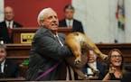 West Virginia Gov. Jim Justice holds up his dog Babydog’s rear end as a message to people who’ve doubted the state as he comes to the end of his S
