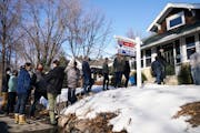 A line of several home shoppers and their real estate agents formed as they waited to view a home for sale in March 2021.
