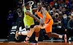 Phoenix Suns center Bismack Biyombo and Timberwolves forward Anthony Edwards battle for a loose ball during the first half Friday night in Phoenix.