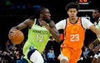 Timberwolves forward Taurean Prince drives as Suns forward Cameron Johnson defends during the first half Friday.