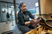 Lisa Cotton shines a pair of boots in her downtown Minneapolis shoeshine stand. Her last day was Tuesday, Feb. 1, 2022 — the 31st anniversary of her