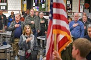 Attendees covered their hearts with their hands as Minnetonka’s Boy Scout Troop 207 posted the colors at the beginning of the GOP Caucus at Eden Pra