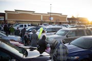 Dozens of people waited in a line that wound through the parking lot of the COVID-19 community testing site in Brooklyn Park in early January.