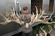 A Minnesota deer farmer shows off antlers from genetically modified monster buck raised in captivity. The display was at outdoors show in Wisconsin in