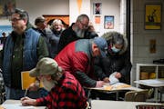 White Bear Lake residents register before the start of a GOP Caucus Tuesday, Feb. 1, 2022 at White Bear Lake Area High School in White Bear Lake, Minn