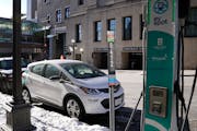 A car from Evie was parked next to an EV charging station on Wacouta Street near the Union Depot on Wednesday in St. Paul.