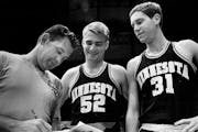 Coach Bill Fitch gave instructions to Gopher captains Larry Overskei, center, and Larry Mikan in 1969.