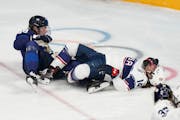Team USA’s Brianna Decker, right, was injured after colliding with Finland’s Ronja Savolainen in the first period of the Americans’ 5-2 victory 