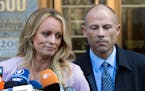 In this April 16, 2018 file photo, adult film actress Stormy Daniels stands with her lawyer Michael Avenatti as she speaks outside federal court, in N