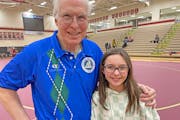 Scot Davis with granddaughter Taylan Mouser, 11, on Thursday, when Davis got his 1,200th victory as a high school wrestling coach.