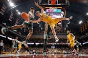Staff photographer Carlos Gonzalez was recognized for his sports photography, including this image of Luke Loewe (12) of Minnesota being blocked while